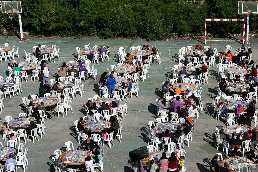 People have breakfast at school hosting displaced Lebanese in the southern city of Sidon