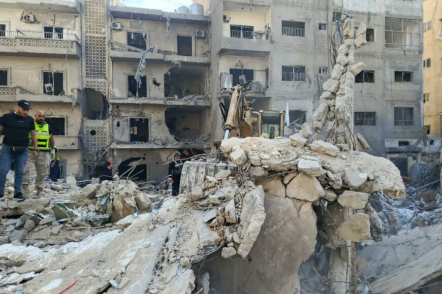 Rescuers and first responders gather at the site of overnight Israeli airstrikes that targeted the southern Lebanese city of Tyre