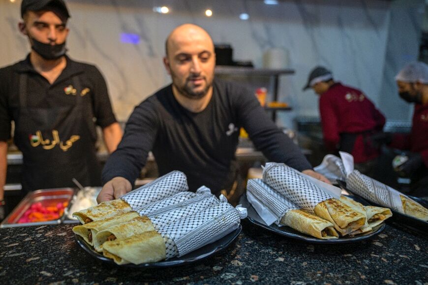 The Hay al-Rimal restaurant serves Gaza-style turkey shawarma sandwiches, wrapped in paper with the keffiyeh pattern of a traditional Palestinian scarf