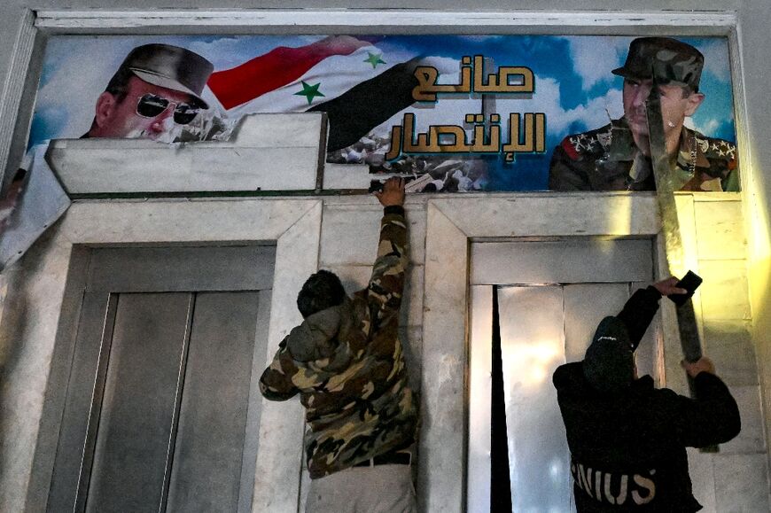 Posters of ousted president Bashar al-Assad and his father Hafez are torn down from the detention centre's upper-floor offices