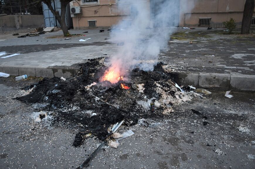 A pile of pills, thought to be the psychostimulant captagon, burns at the airbase