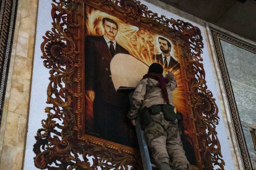 A rebel fighter at Aleppo airport tears a portrait of the Assad family from its frame.