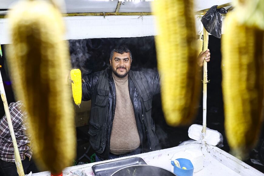 A vendor sells corn from a stall in Aleppo