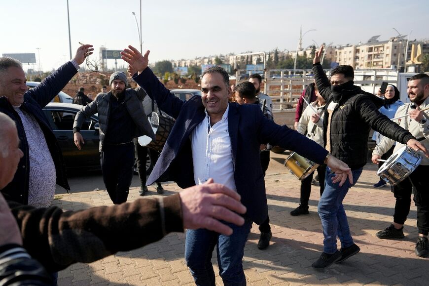 Men just freed from prison dance at the entrance to Aleppo -- the Assad system of rule relied on a brutal complex of detention centres