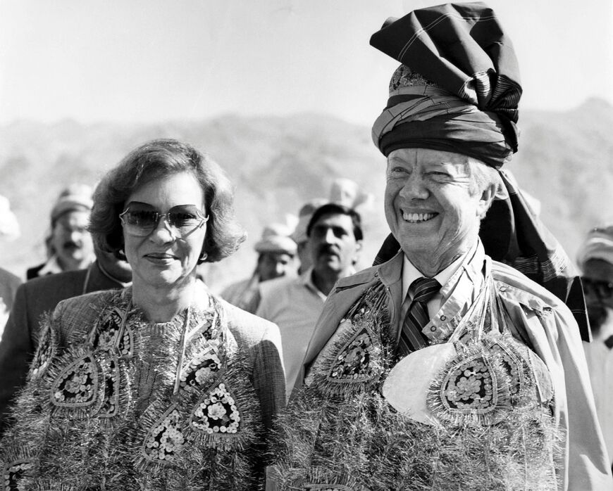 Former US president Jimmy Carter, accompanied by his wife Rosalynn, wears a pathan turban and glittering garlands presented by the Pakistani tribesmen at Michini Point on the Khyber Pass in November 1986