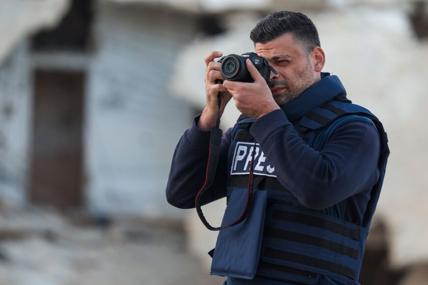 This file picture shows Syrian photographer Anas Alkharboutli at work for German press agency DPA in the northern town of Ariha on November 10.