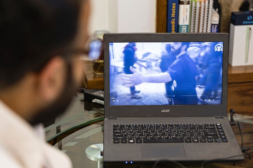 Orthopaedic surgeon Mohammed al-Hanash watches a video from April 2018 of Muwafaq Nisrin, who worked as an emergency responder and nurse, providing assistance to a victim in Douma 