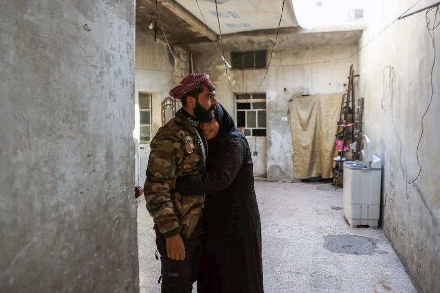 After eight years of separation, Bahria Bakur (R) hugs her son Mohammed Jomaa as they reunite in Aleppo after its fall from government control to Islamist-led rebels