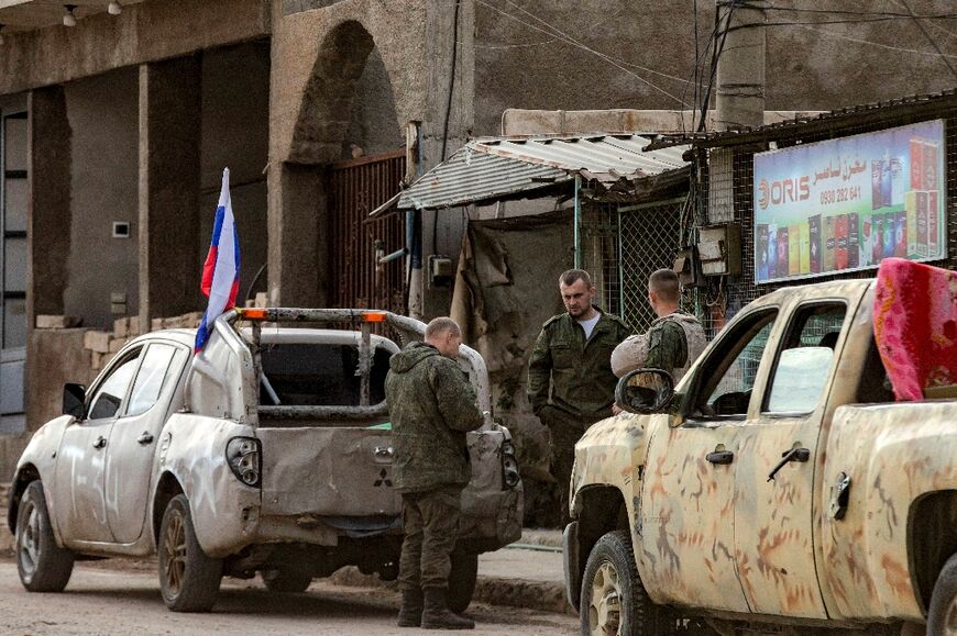 Russian soldiers prepare to evacuate a position in the northeastern city of Qamishli in the aftermath of the overthrow of their ally Bashar al-Assad.