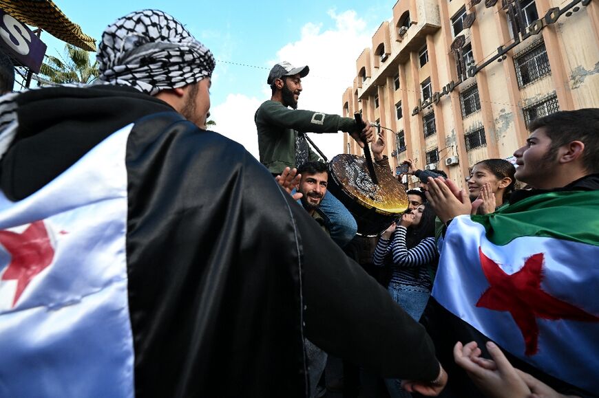 People celebrate the collapse of Bashar al-Assad's rule in Sweida, the heartland of Syria's Druze minority 