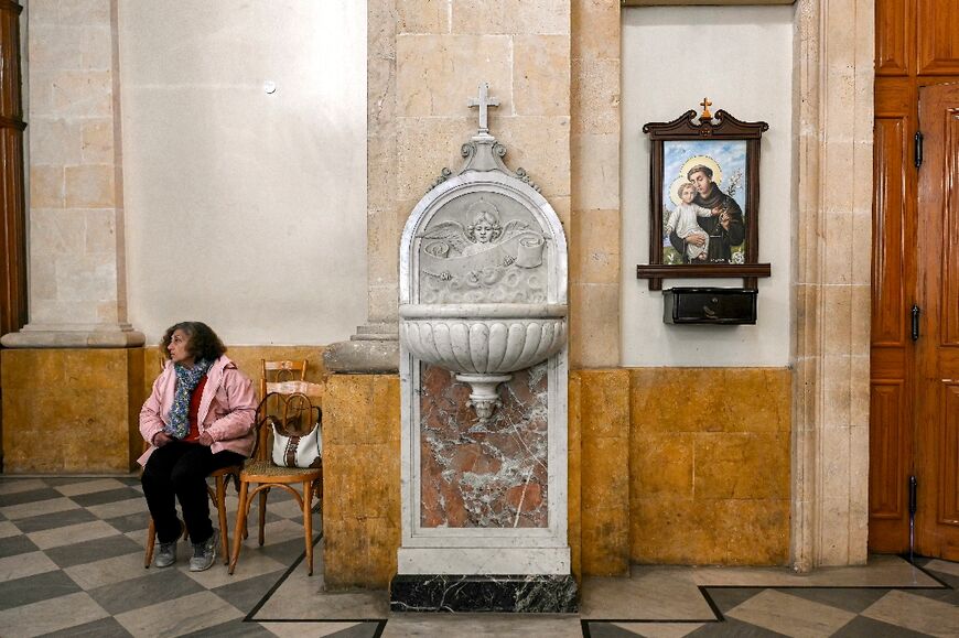 A woman parishioner sits during mass at the Latin cathedral in Aleppo.