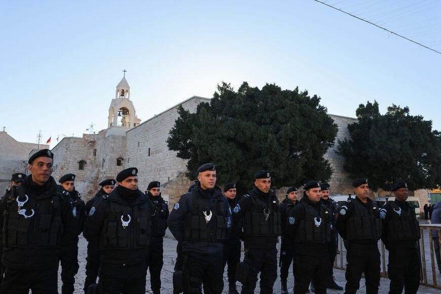 Palestinian policemen stand guard at Manger Square on Christmas eve outside Bethlehem's Church of the Nativity