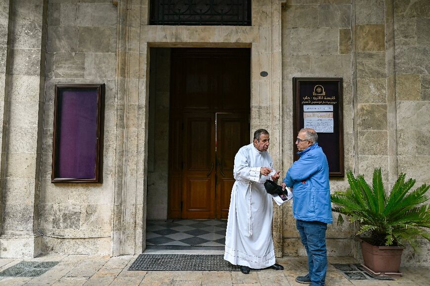 A priest speaks with a lay official at the Latin cathedral in Aleppo.