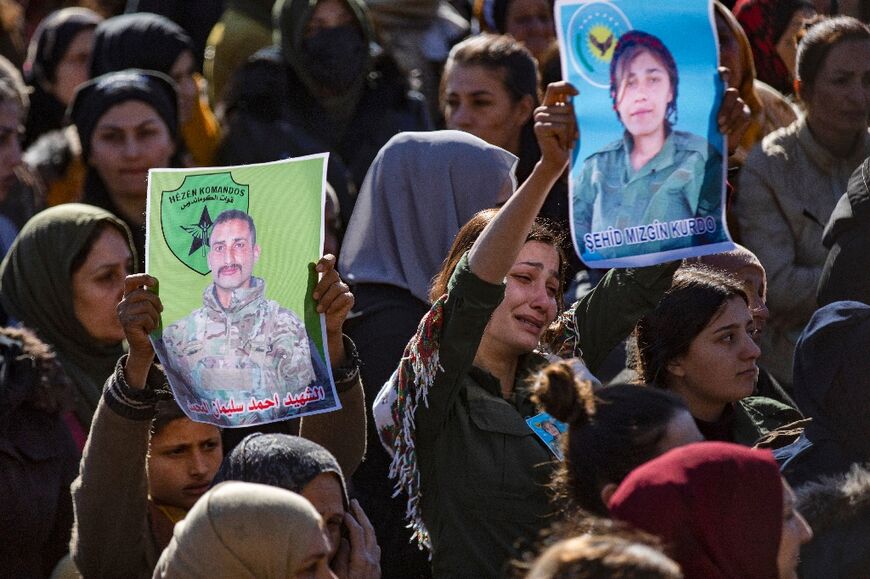 People in Qamishli, northeast Syria, attend the funeral of two fighters of the Kurdish-led Syrian Democratic Forces (SDF) who were killed together with three others in Manbij during clashes with Turkish-backed opposition factions after Assad's fall