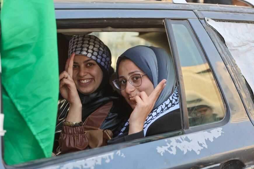 Two women smile in Gaza City, expecting the ceasefire to take effect