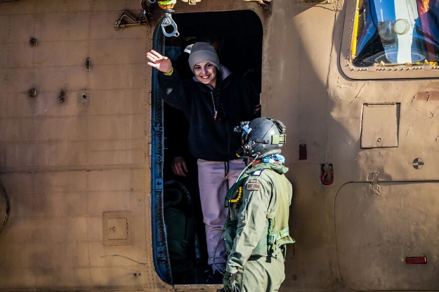 Newly released Israeli hostage Daniella Gilboa waves as she leaves a military helicopter at a central Israeli hospital