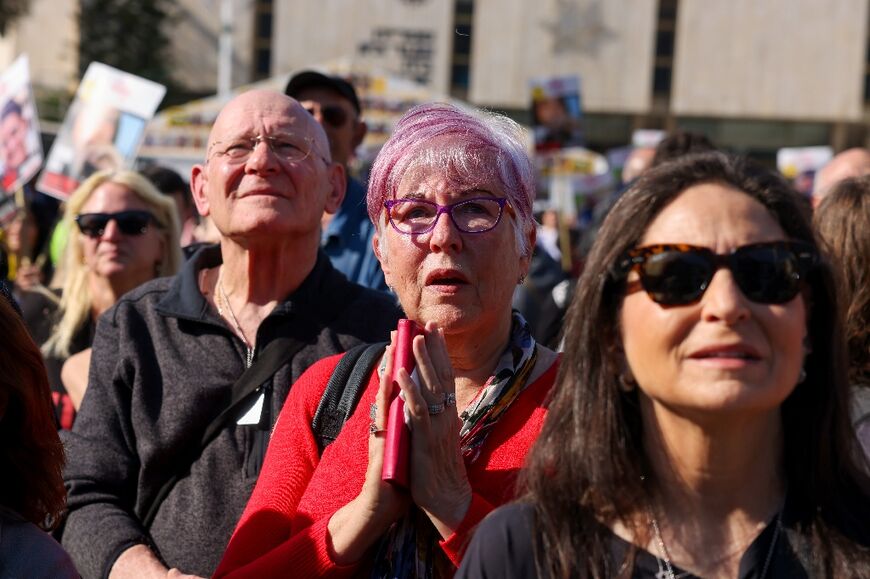 Israelis in Tel Aviv watch live television coverage of the latest hostage release.