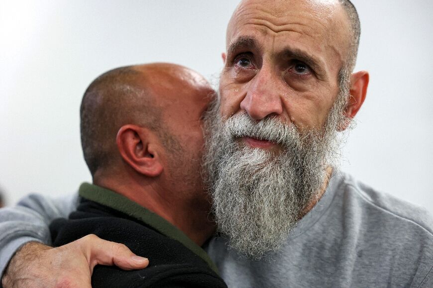 A well-wisher embraces freed prisoner Raed al-Saadi, 56, who spent 36 years behind bars.