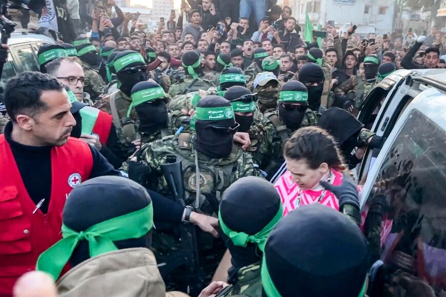 An image grab shows one of the Israeli hostages exiting a vehicle to be handed over to the International Committee of the Red Cross in Gaza City