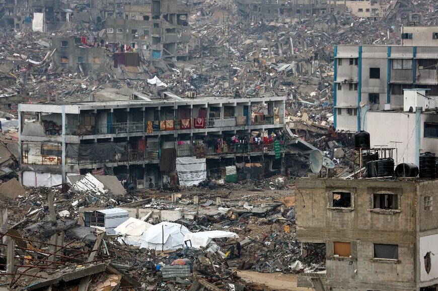 People camp in a heavily damaged UN school surrounded by destruction, as displaced Palestinians return to northern areas of the Gaza Strip