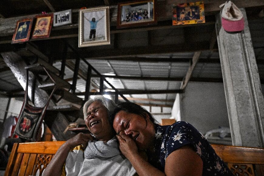 Wiwwaeo Sriaoun (R), the mother of Thai farm worker Watchara Sriaoun who was held hostage in Gaza, cries after receiving confirmation of the release of her son