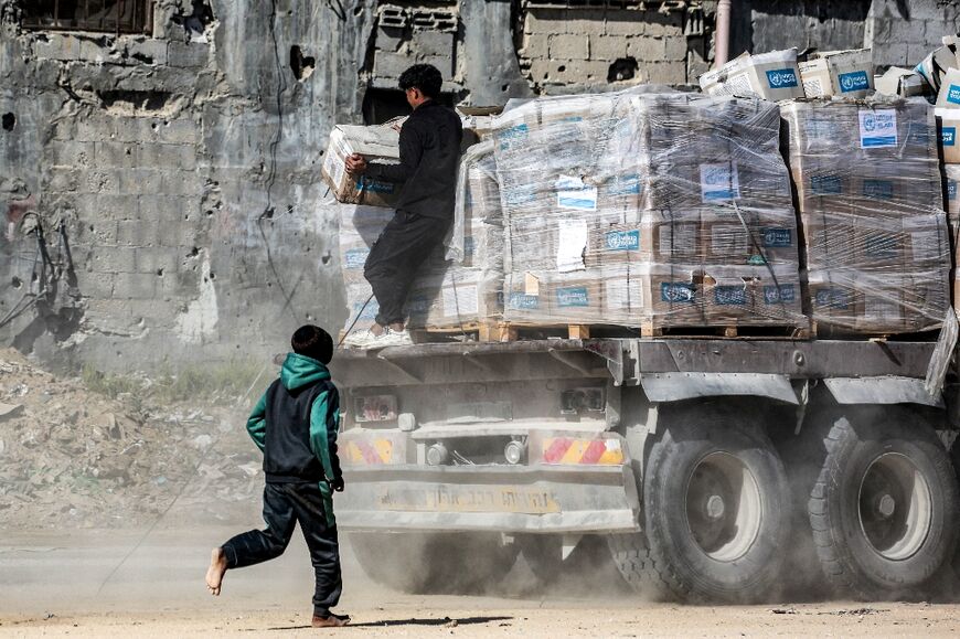 A Palestinian boy chases after a relief truck bringing desperately needed food into Gaza as part of the aid surge that has accompanied the ceasefire which began last weekend.