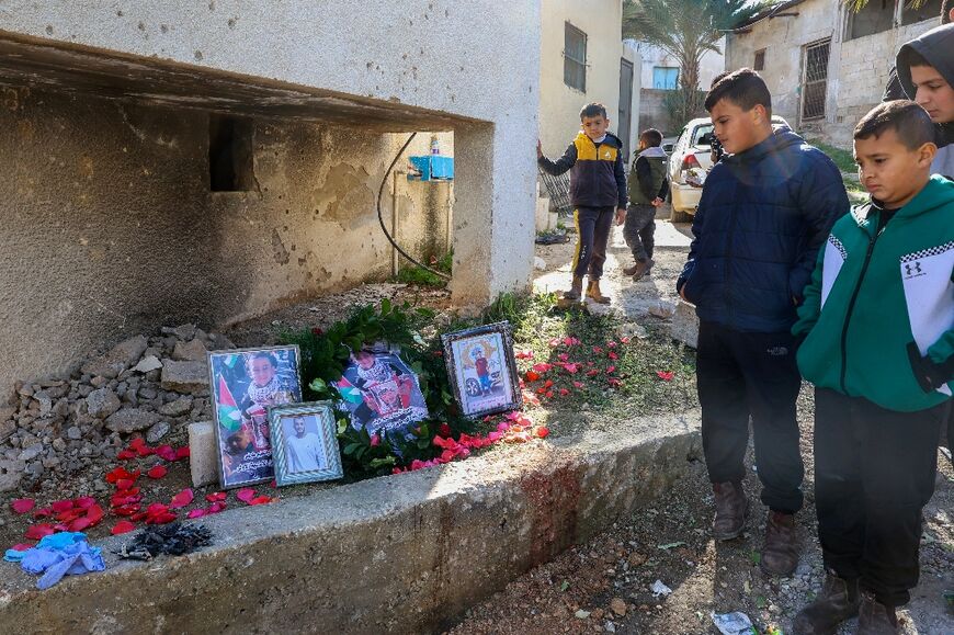 Friends and relatives of the youngsters killed in the Israeli strike inspect a makeshift memorial set up in the West Bank village of Tammun.