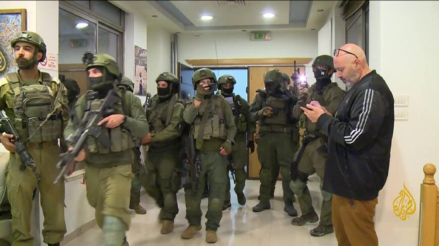 Israeli soldiers enter Al Jazeera's Ramallah office in September to issue a 45-day closure order.