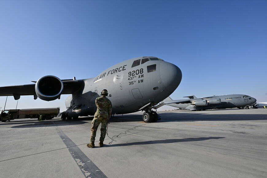 A US military transport aircraft, which will carry humanitarian aid parcels for the Gaza Strip, is pictured on the tarmac at the Al-Udeid air base southwest of Doha on March 21, 2024. (Photo by Giuseppe CACACE / AFP) (Photo by GIUSEPPE CACACE/AFP via Getty Images)