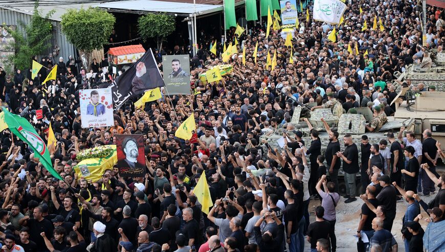 Mourners carry the coffins of people killed after hundreds of paging devices exploded in a deadly wave across Lebanon the previous day, during their funeral procession in Beirut's southern suburbs on September 18, 2024.