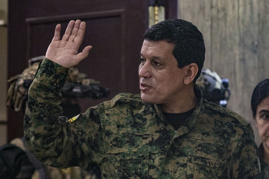 Syrian Democratic Forces (SDF) commander-in-chief Mazloum Abdi, waves after giving a press conference in Syria's northeastern city of Hasakeh on December 6, 2024. Abdi said on December 6 that he was open to talks with Turkey and Islamist-led rebels, whose offensive had created a "new political and military reality". (Photo by Delil SOULEIMAN / AFP) (Photo by DELIL SOULEIMAN/AFP via Getty Images)