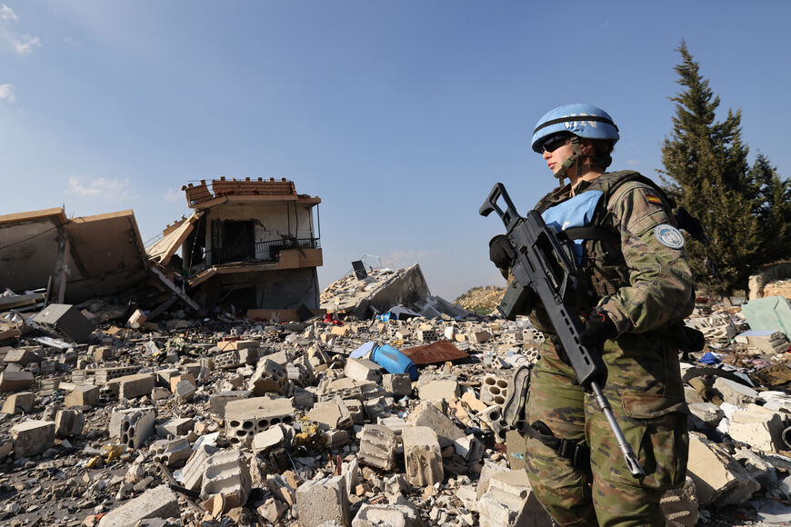 A member of the Spanish UNIFIL peacekeepers forces stands in front of the rubble of destroyed buildings during a patrol in the southern Lebanese village of Borj El Mlouk, near the border with Israel, on January 7, 2025, amid a fragile truce between Israel and Hezbollah. (Photo by ANWAR AMRO / AFP) (Photo by ANWAR AMRO/AFP via Getty Images)