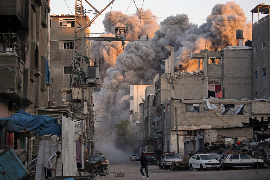 TOPSHOT - Smoke rises from a building destroyed in Israeli airstrike at the Bureij camp for Palestinian refugees in the central Gaza Strip on January 12, 2025, as the war between Israel and Hamas militants continues. (Photo by Eyad BABA / AFP) (Photo by EYAD BABA/AFP via Getty Images)