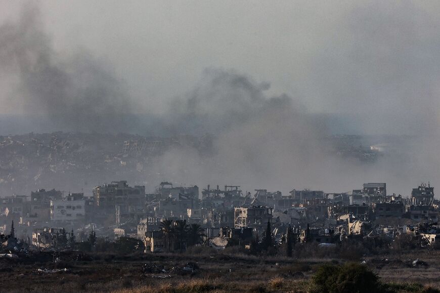 Smoke rises over bombed out buildings in northern Gaza, where Israeli troops have kept up a major offensive since October 6.