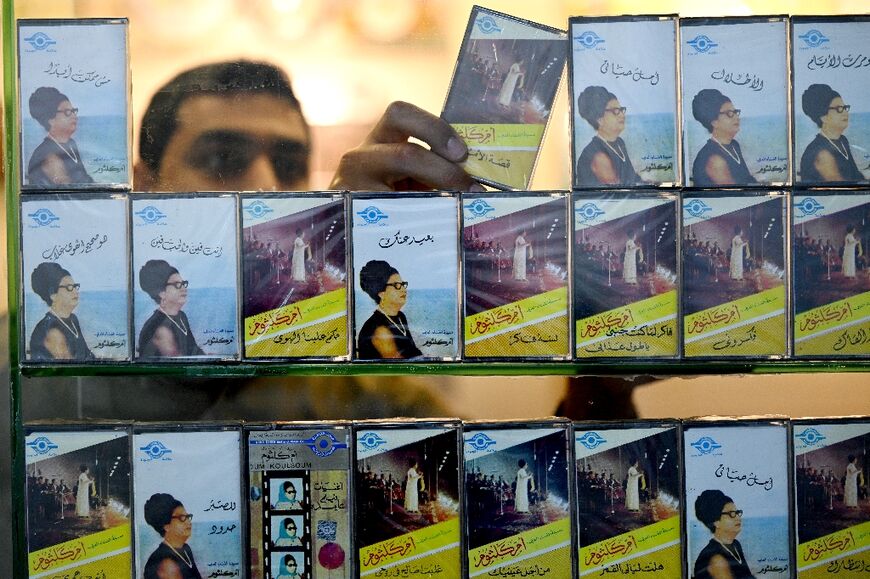 A man arranges audio tapes of Umm Kulthum, who rose from humble beginnings to become the most celebrated voice in the Arab world, at a shop in Kuwait City