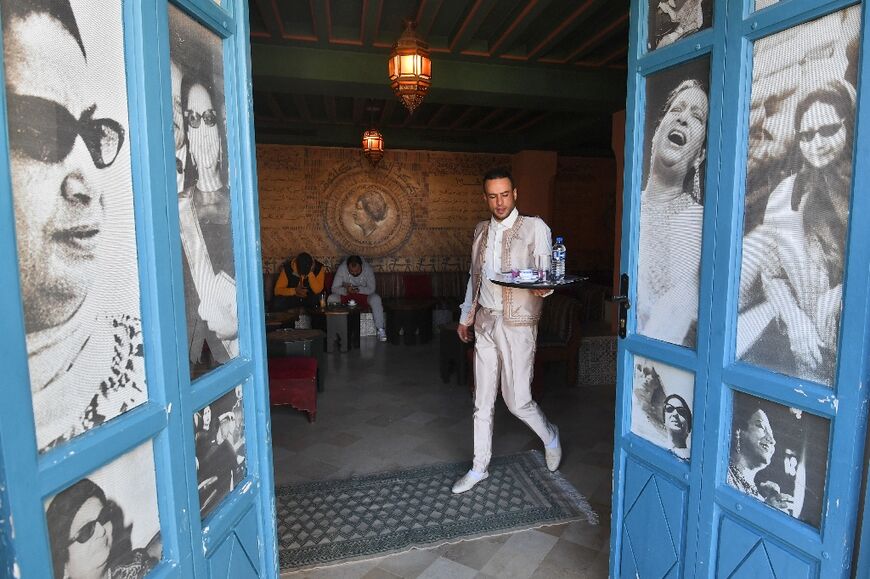 A waiter carries drinks at the Umm Kulthum cafe in the Tunisian tourist town of Hammamet