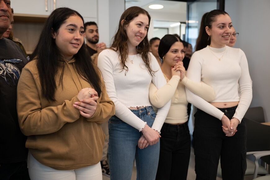 An Israeli army picture shows former hostages (L to R) Liri Albag, Naama Levy, Daniella Gilboa and Karina Ariev watching footage of Agam Berger being freed