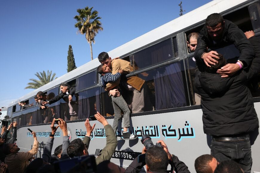 Some released prisoners, too excited to wait, began their reunion from the bus windows as they reached Gaza