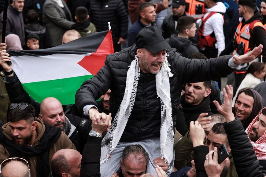 A former Palestinian prisoner is carried through crowds celebrating his release from Israeli jail