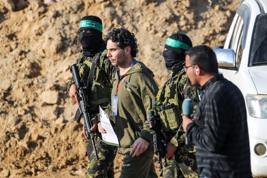 Palestinian militant group Hamas fighters escort French-Israeli hostage Ofer Kalderon before handing him over to a Red Cross team in Khan Yunis