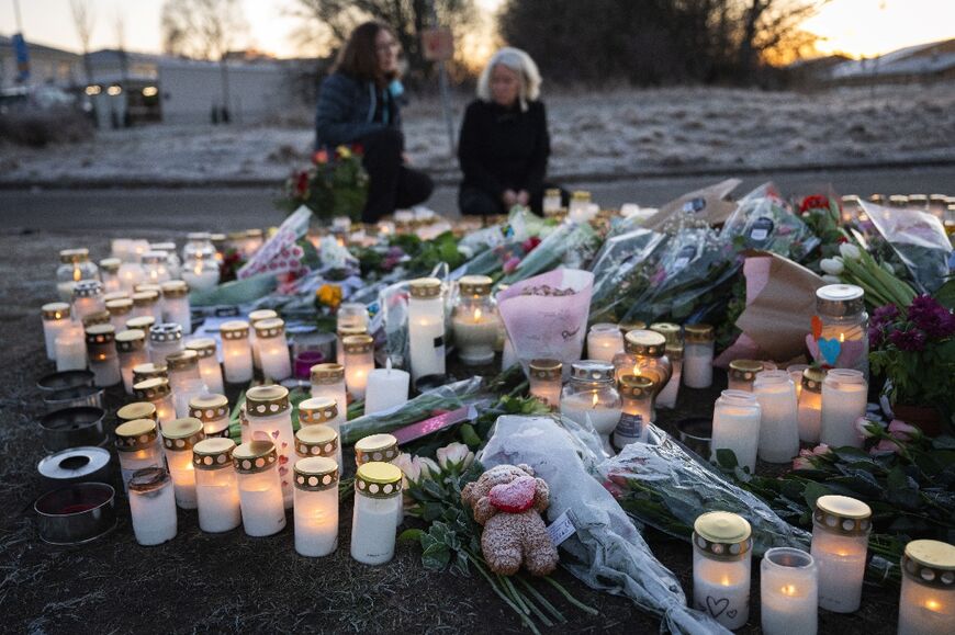 Flowers and candles have been left at the scene of the shooting