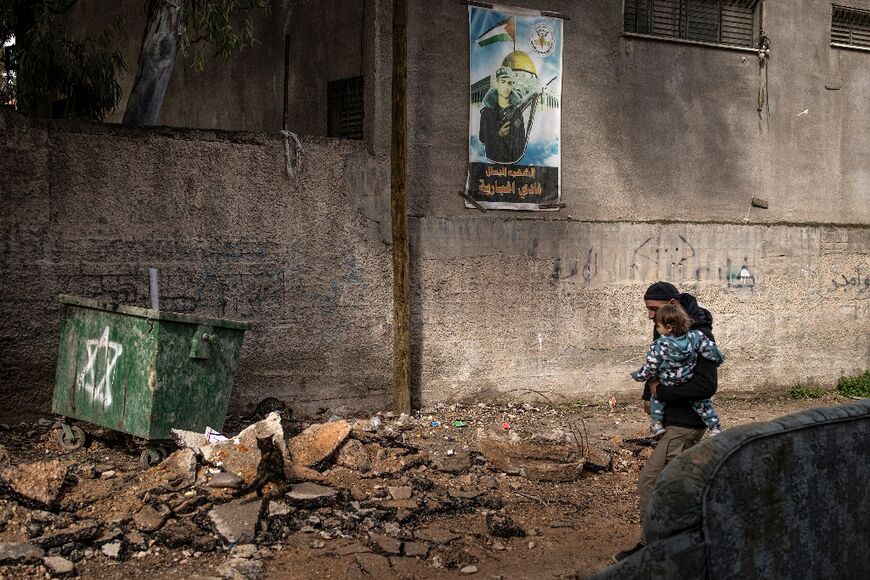 A bulldozer has ripped through the street, a common sight during Israeli raids which the military says aims to clear roads of explosives