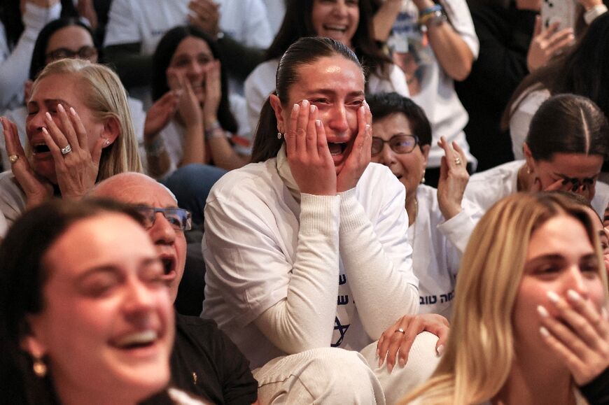 Dana Shem Tov (C) the sister of Israeli hostage Omer Shem Tov, reacts at the family home in Tel Aviv during his televised release by Hamas militants in Gaza