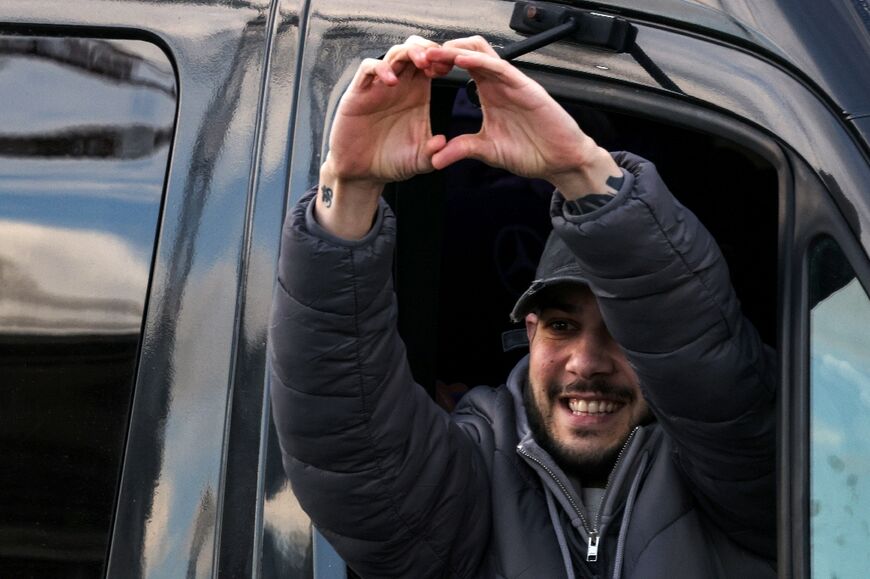 Newly-released Israeli hostage Eliya Cohen gestures as he arrives in a vehicle at Beilinson Hospital in the Rabin Medical Centre in Petah Tikva in central Israel 