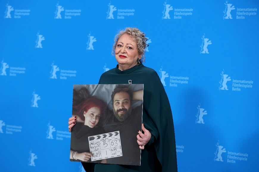 Lead actress Lili Farhadpour holds up a photo of directors Maryam Moghadam and Behtash Sanaeeha at the Berlin Film Festival last year 