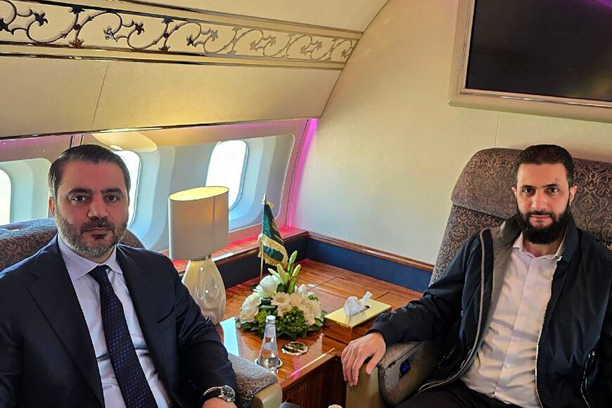 Syria's interim president and foreign minister were shown heading to Saud Arabia in a handout picture from state news agency SANA