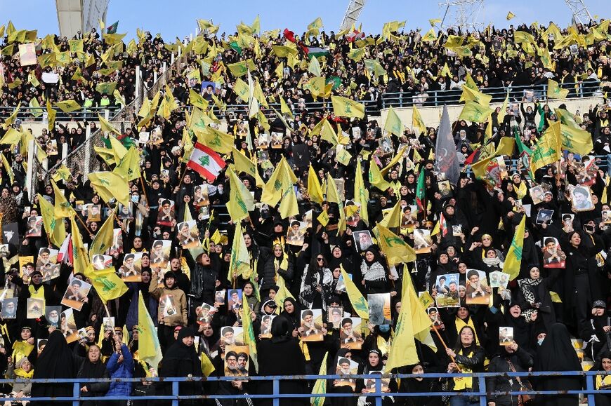 Tens of thousands of people dressed in black and waving Hezbollah's yellow flag attended the funeral