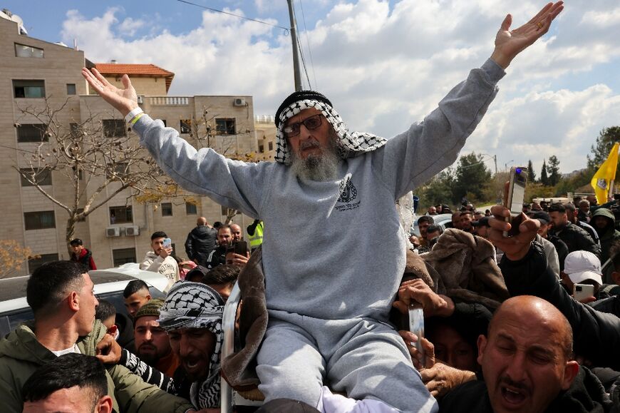 A former prisoner released by Israel is carried along shoulder-high