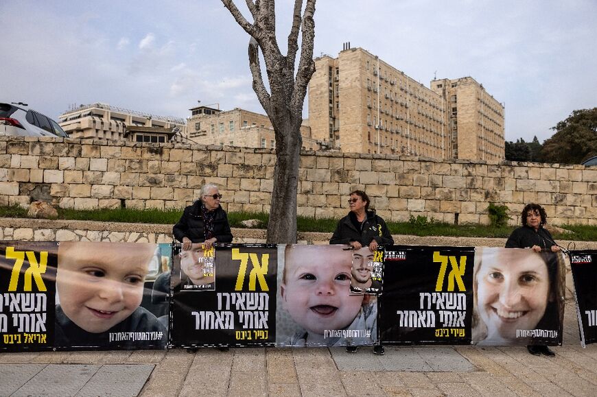 Portraits of Shiri Bibas and her children Ariel and Kfir, all Israeli hostages in Gaza, at a rally outside the prime minister's office in Jerusalem