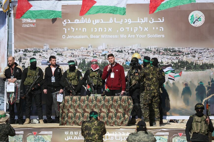 Hostages (L to R) Yair Horn, Sagui Dekel-Chen and Sasha Trupanov appear on stage in Gaza ahead of their release